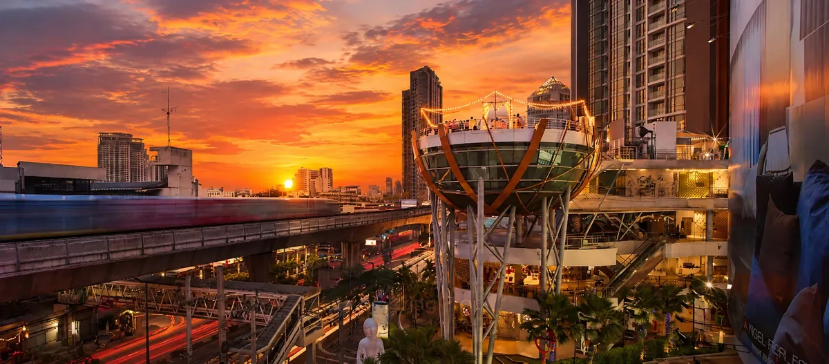 BTS Skytrain and shopping mall at sunset in the Phra Khanong–On Nut district of Bangkok, Thailand