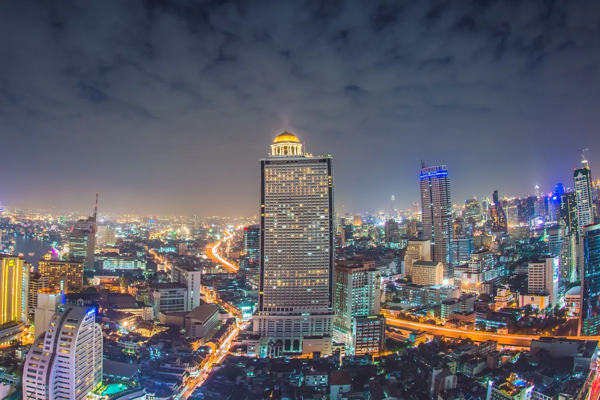 Night skyline of the Silom–Sathorn business district with State Tower in Bangkok, Thailand