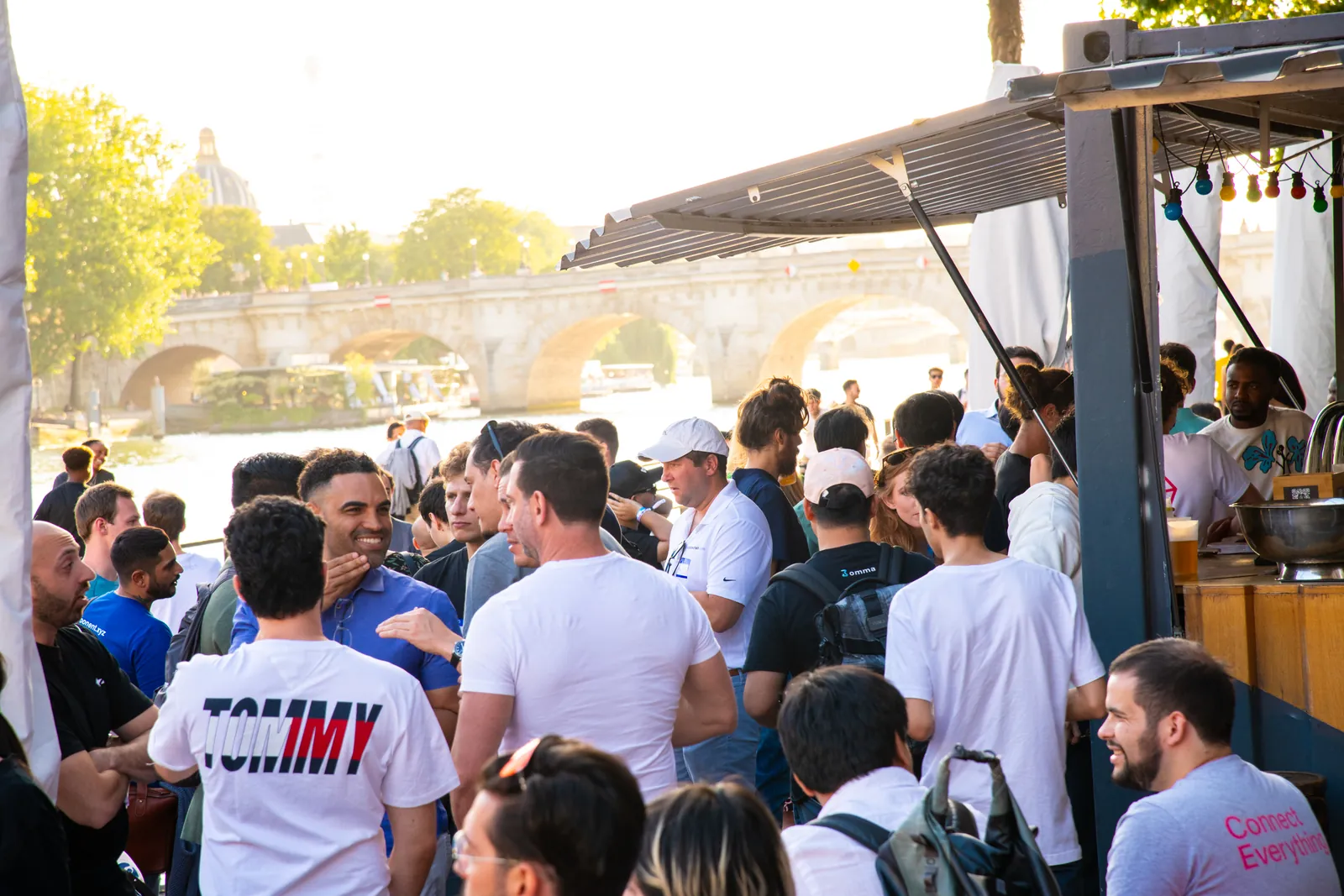Guests networking at a riverside bar beside the Seine during EthCC week in Paris