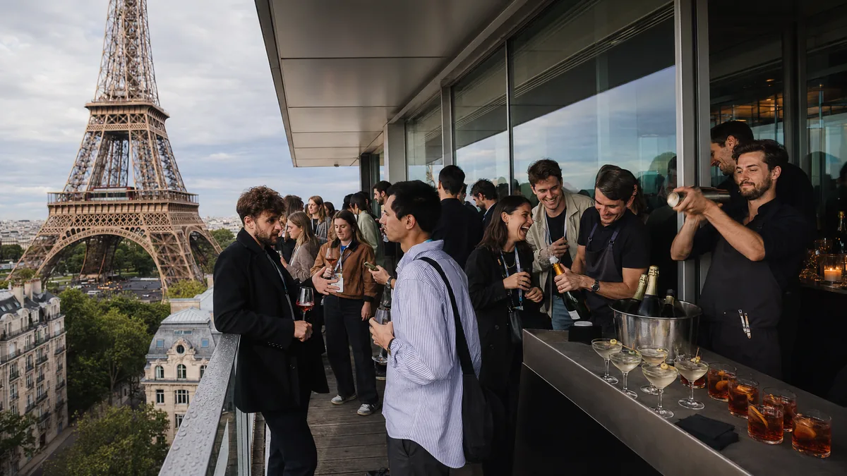 Delegates on a terrace facing the Eiffel Tower at App Growth Summit Paris, produced by CH3 Agency