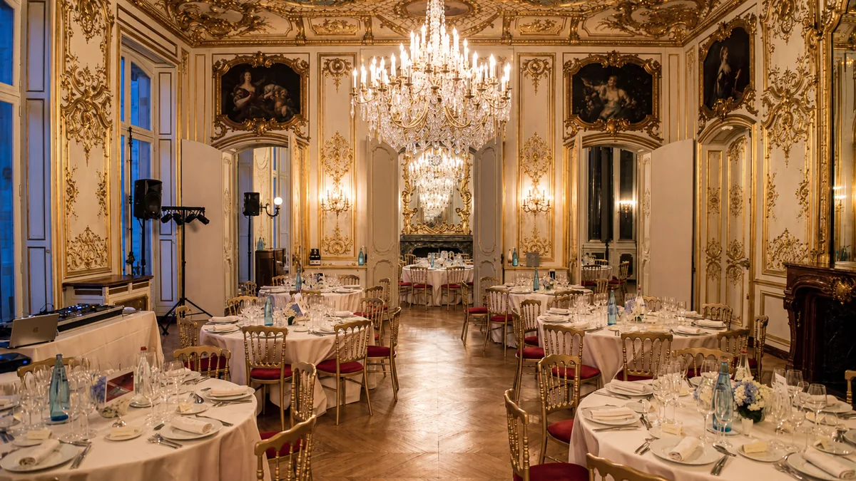 A gilded salon set for dinner at Hotel Le Marois