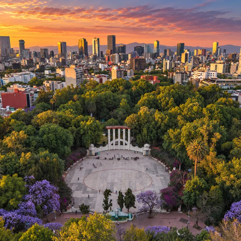 Park plaza framed by jacarandas and trees in Condesa, Mexico City &mdash; CH3 Agency