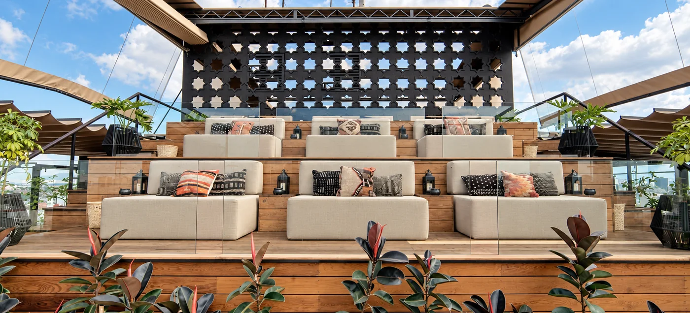 Timber deck rooftop terrace with bench seating and open city views at Supra Roma, Roma Norte, Mexico City