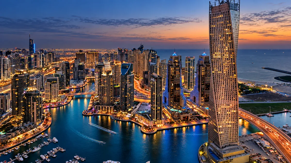United Arab Emirates, Dubai — Dubai Marina towers and yacht berths at sunset